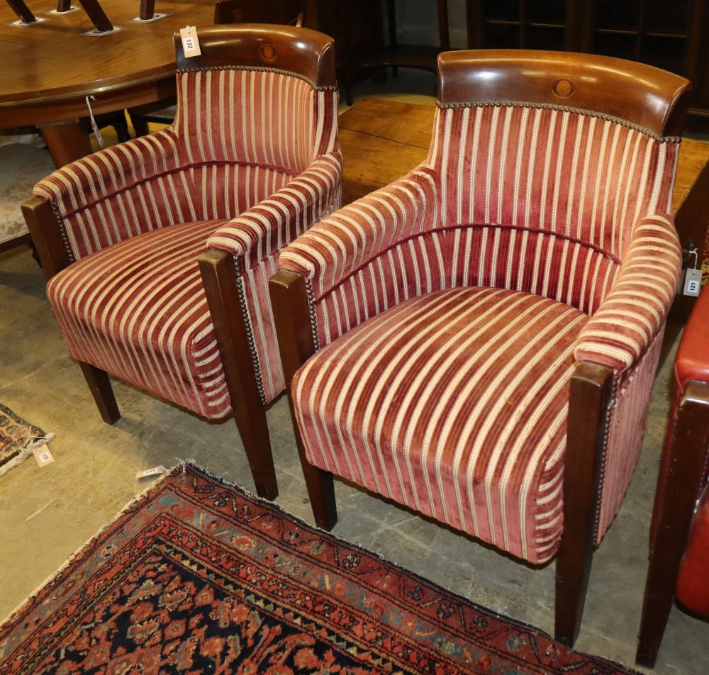 A set of four mahogany framed tub shaped theatre viewing armchairs, with red and cream striped upholstery (by repute from Croydon Theat